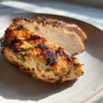 Close-up of perfectly cooked, sliced chicken breast showing a juicy interior after using the chicken marinade.