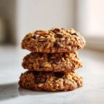 A tempting stack of three freshly baked oatmeal cookie treats loaded with chocolate chips.