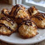 A plate of freshly baked Coconut Macaroons with Dark Chocolate Drizzle, featuring toasted edges.