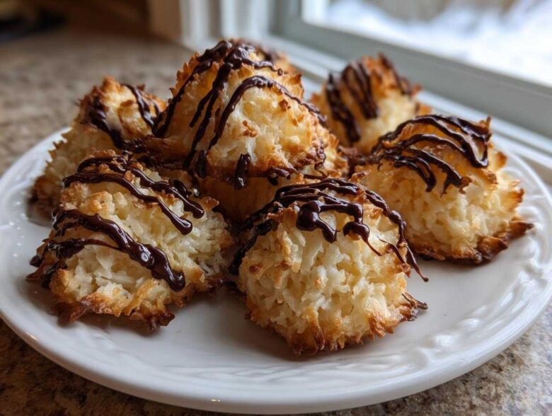 A plate of freshly baked Coconut Macaroons with Dark Chocolate Drizzle, featuring toasted edges.