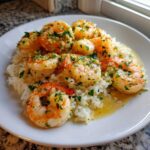 A plate of Garlic Butter Shrimp and Rice Skillet, featuring plump shrimp coated in garlic butter and parsley over white rice.