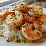 Close-up of Garlic Butter Shrimp and Rice Skillet featuring plump shrimp over white rice with garlic butter sauce and parsley.