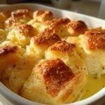 Close-up of freshly baked Garlic Parmesan Pull-Apart Bread glistening with butter in a white ceramic dish.