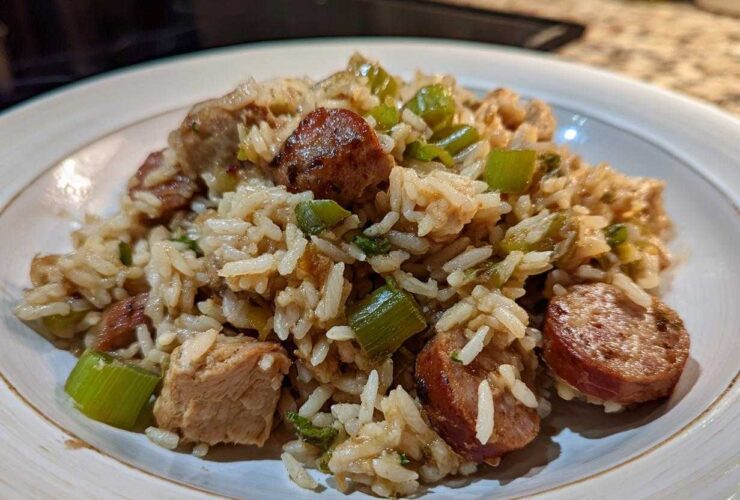 Close-up of a serving of One-Pot Chicken Jambalaya featuring rice, chicken chunks, and sliced smoked sausage.