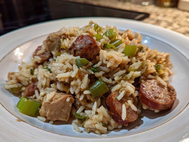Close-up of a serving of One-Pot Chicken Jambalaya featuring rice, chicken chunks, and sliced smoked sausage.