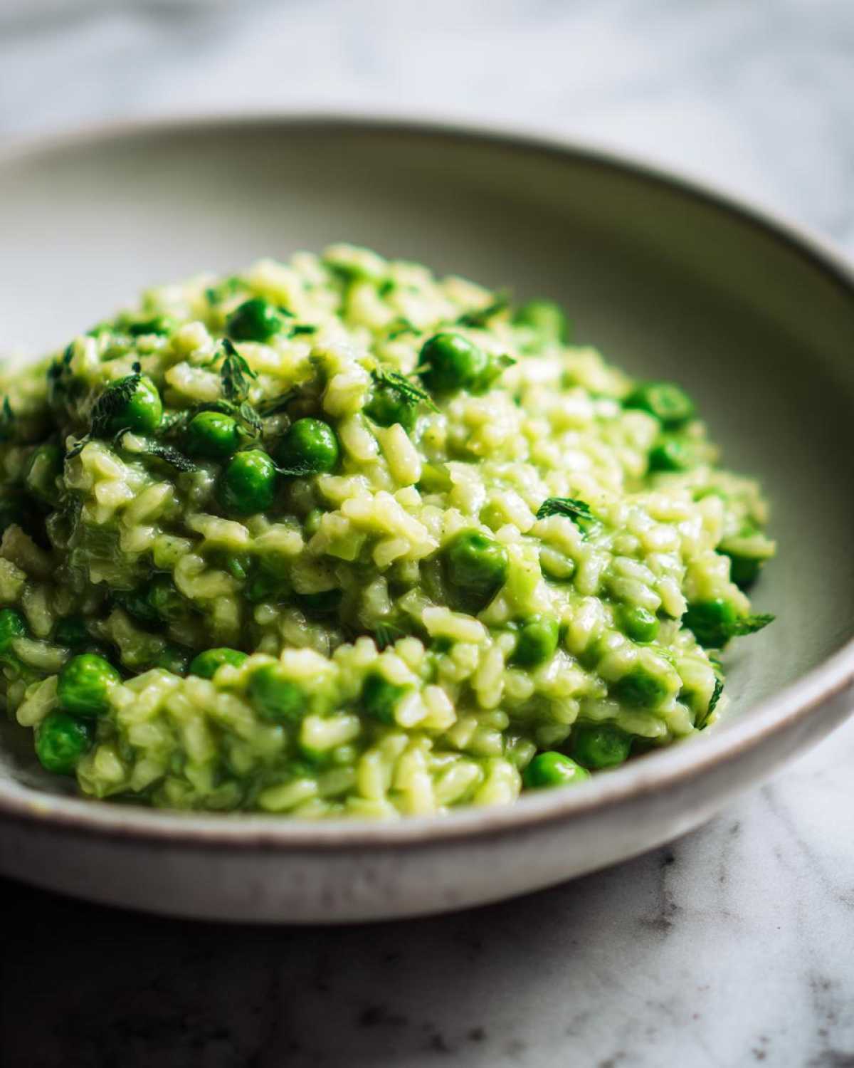 Close-up of creamy Spring Pea and Mint Risotto studded with bright green peas and fresh mint.