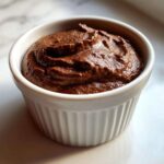 Close-up of rich, dark Vegan Chocolate Avocado Mousse served in a white fluted ramekin.
