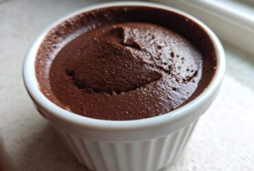 Close-up of rich, dark Vegan Chocolate Avocado Mousse served in a white, fluted ramekin.