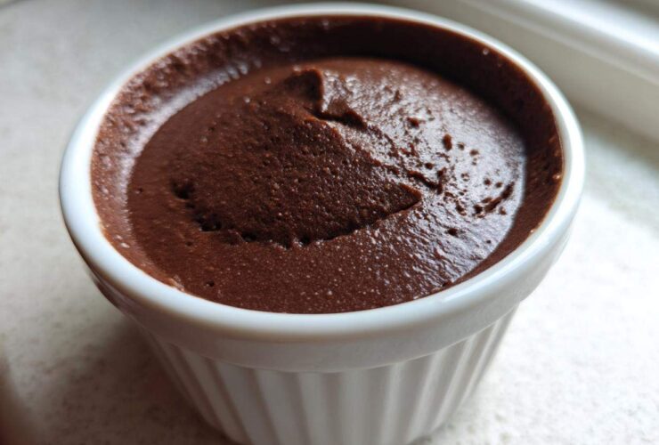 Close-up of rich, dark Vegan Chocolate Avocado Mousse served in a white, fluted ramekin.