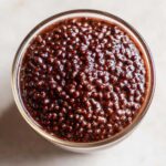 Overhead close-up of rich, dark Vegan Chocolate Chia Pudding showing the swollen texture of the chia seeds.