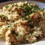 Close-up of Garlic Butter Rice with Chicken Skillet, garnished with fresh parsley.
