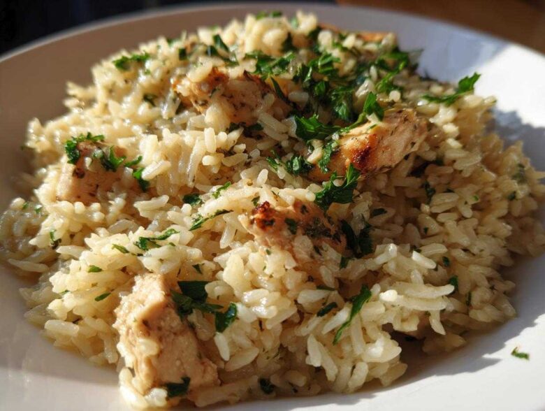 Close-up of Garlic Butter Rice with Chicken Skillet, garnished with fresh parsley.