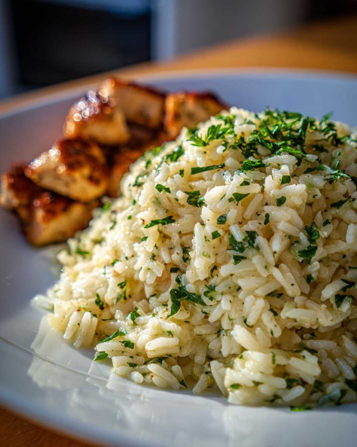 Close-up of fluffy Garlic Butter Rice with Chicken Skillet, topped with fresh parsley.