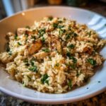 Close-up of Garlic Butter Rice with Chicken Skillet, topped generously with fresh chopped parsley.