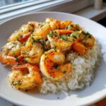 Close-up of Garlic Butter Shrimp and Rice Easy Recipe, featuring plump shrimp coated in garlic butter and parsley over white rice.