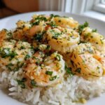 Plated serving of Garlic Butter Shrimp and Rice Easy Recipe, topped with fresh parsley.