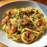 Close-up of Garlic Butter Shrimp Pasta with fettuccine noodles tossed in a rich cream sauce and topped with parsley.