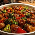Close-up of Honey Soy Chicken Skillet with glossy chicken pieces, bright green broccoli, and red peppers.