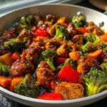 Close-up of Honey Soy Chicken Skillet with Veggies, featuring glazed chicken pieces, bright broccoli florets, and red peppers.