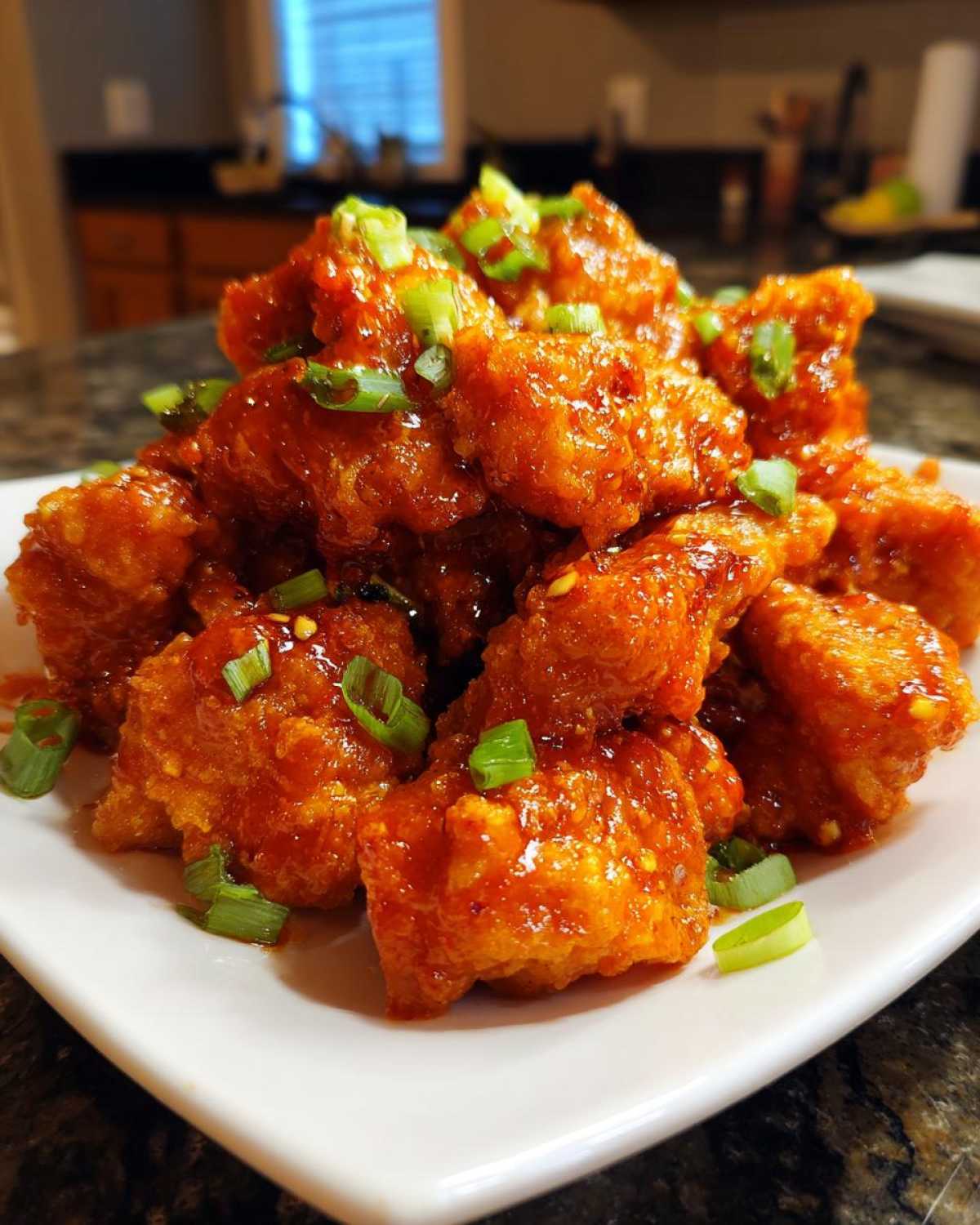 Close-up of crispy chicken pieces coated in glossy sauce for Sticky Sweet Chili Chicken Easy Recipe.
