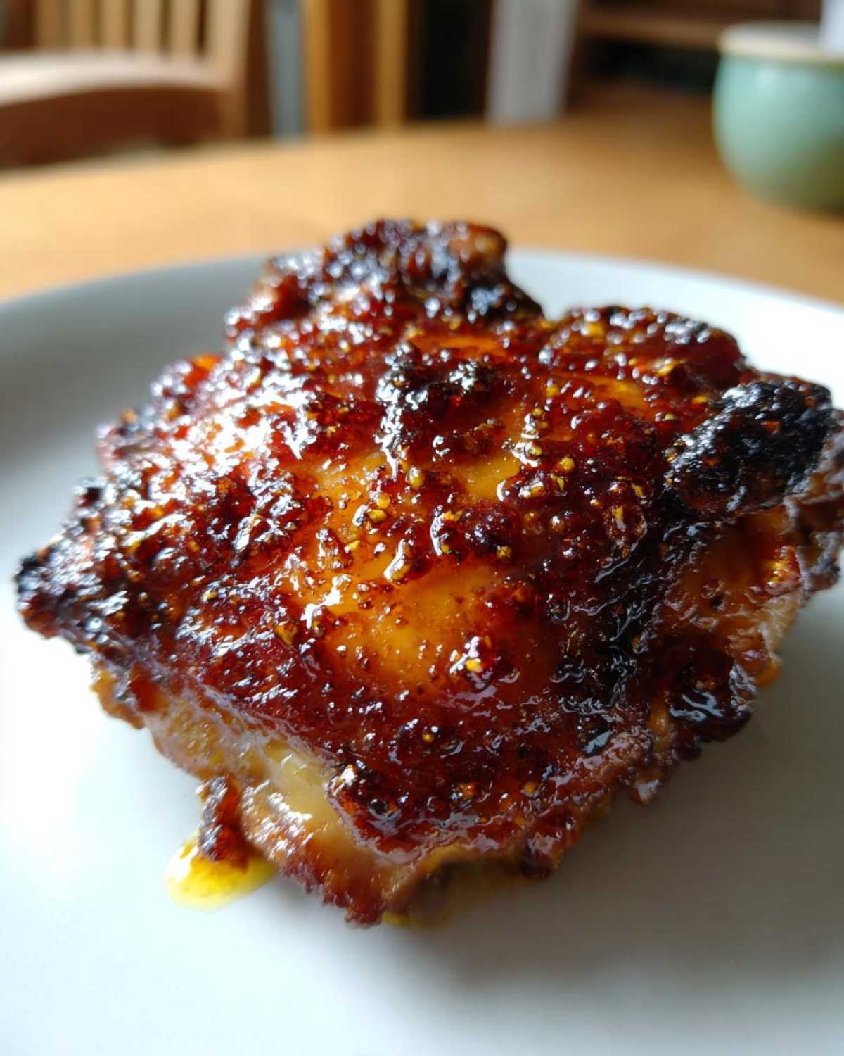 Close-up of a perfectly cooked Honey Garlic Chicken Thighs with a dark, glossy, and crispy skin.