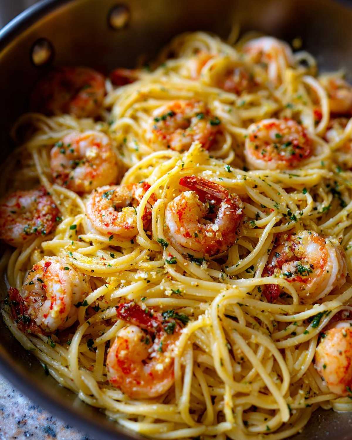 Close-up of Lemon Butter Shrimp Pasta Ready in 20 Minutes tossed with shrimp and herbs in a skillet.