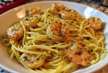 Close-up of Lemon Butter Shrimp Pasta tossed in a light sauce with visible parsley and garlic.